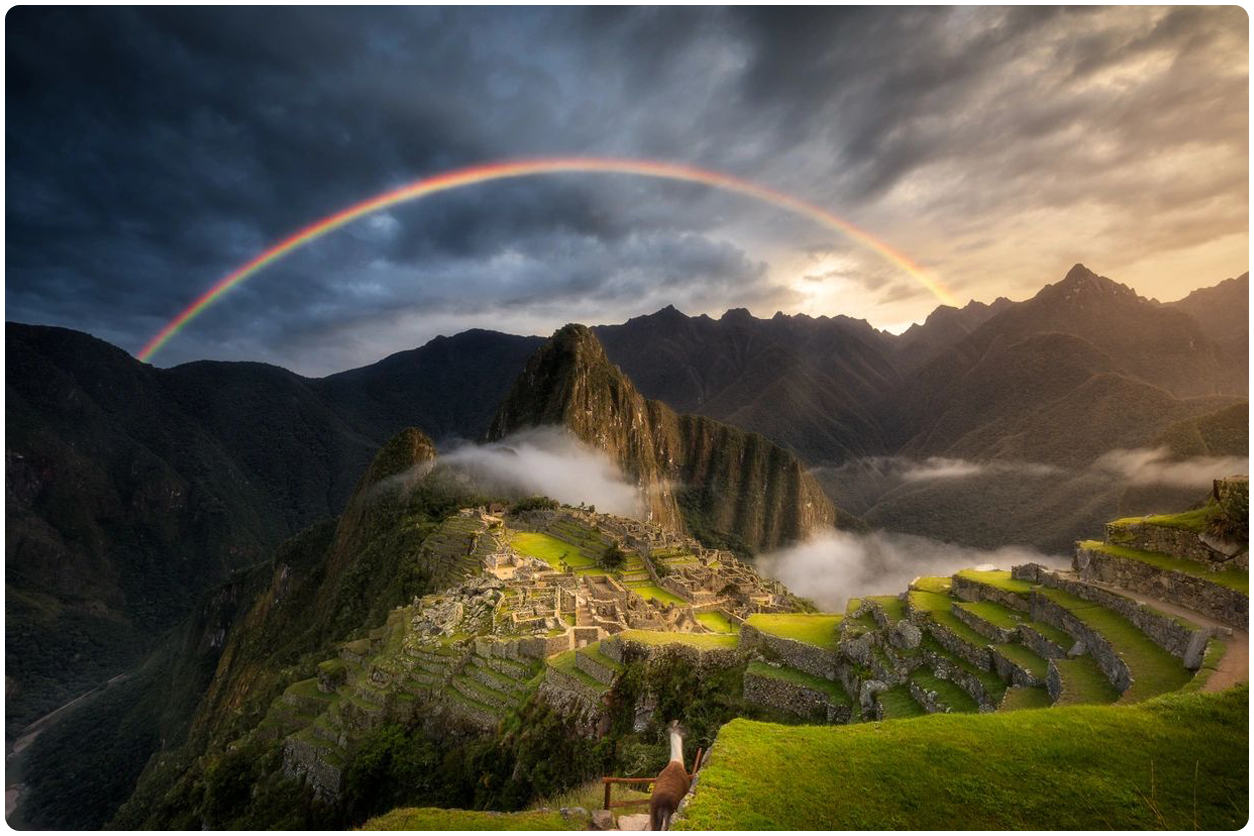 A rainbow over the mountains and machu picchu